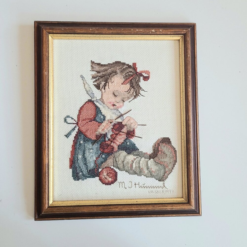 Vintage M J Hummel1997 framed needlepoint picture with knitting little girl.